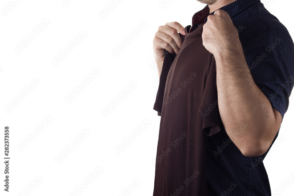 A man trying on a t-shirt on white background. Copy space for text on the left side