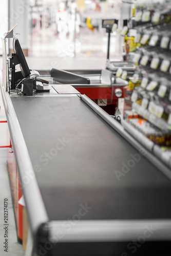 Empty cash desk with closed way border in supermarket