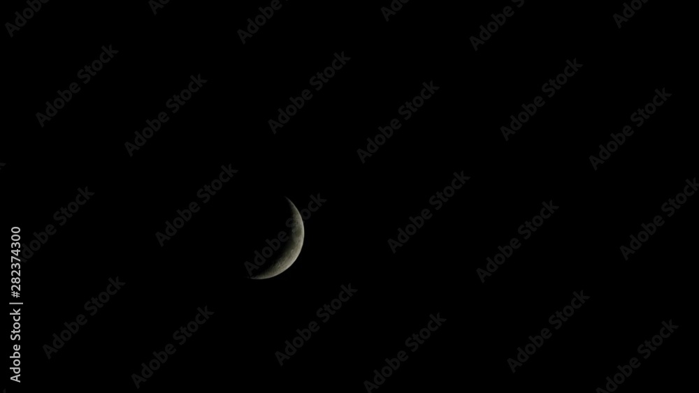 Crescent moon in dark sky, ramadan concept. Time lapse Crescent moon in dark sky, ramadan concept. Time lapse