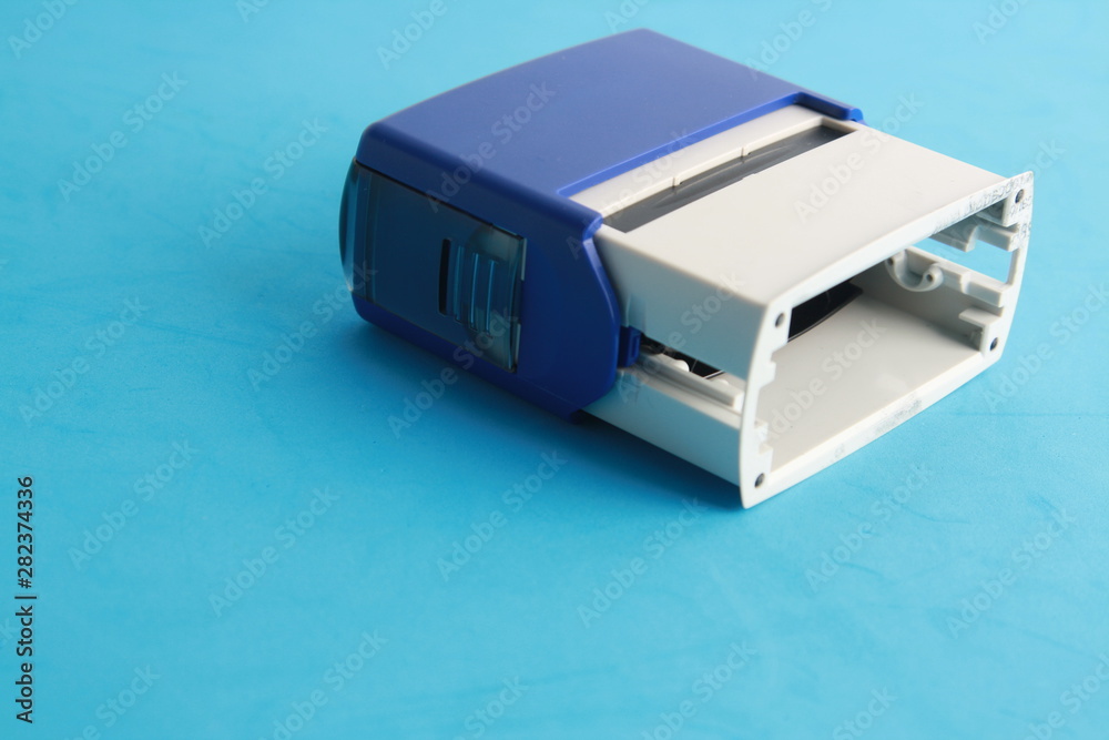 Fototapeta premium Automatic ink stamp manufactured in blue plastic