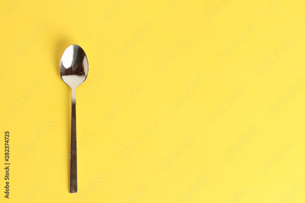 silver spoon isolated on colorful background silver spoon isolated on colorful background