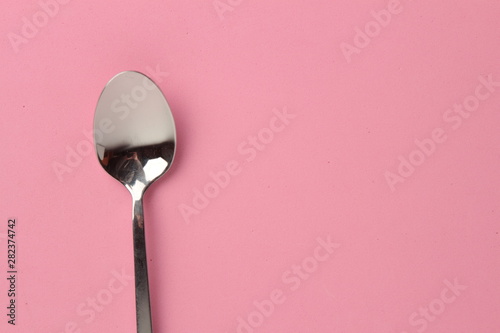 silver spoon isolated on colorful background