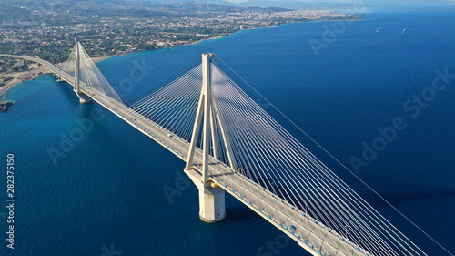 Aerial drone photo of world famous cable suspension bridge of Rio - Antirio Harilaos Trikoupis, crossing Corinthian Gulf, mainland Greece to Peloponnese, Patras