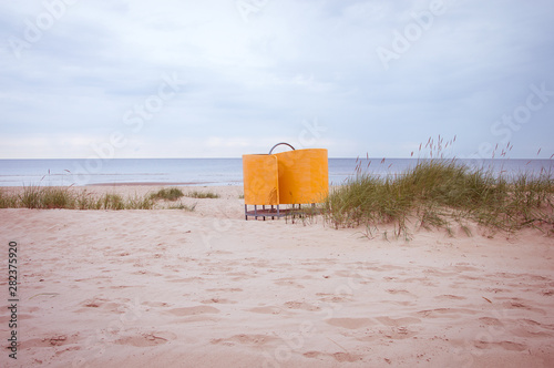 Fototapeta Naklejka Na Ścianę i Meble -  Pink beach seascape view with a pop of yellow color changing room