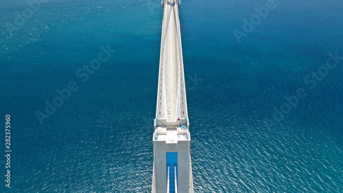 Aerial drone photo of modern cable anti seismic bridge crossing deep blue sea photo