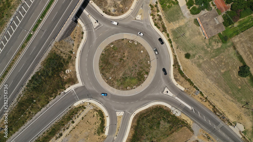 Aerial drone top view photo of modern roundabout as seen in low traffic motorway outside city centre