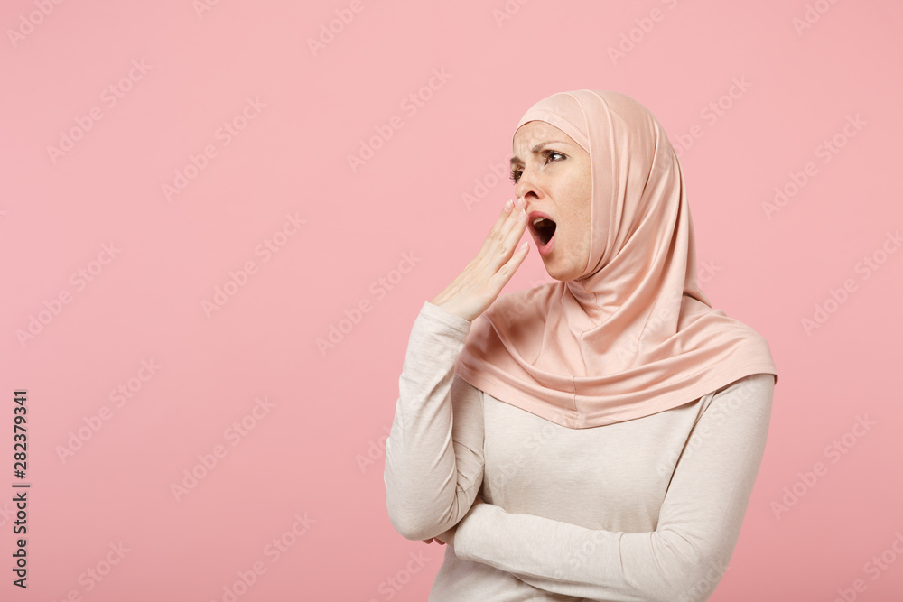 Tired boring arabian muslim woman in hijab light clothes posing