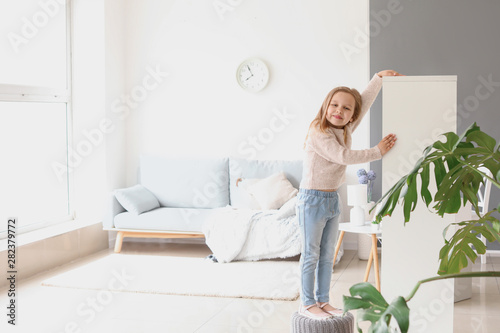 Cute little girl measuring ...