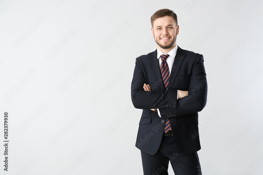 Handsome businessman on light background Handsome businessman on light background