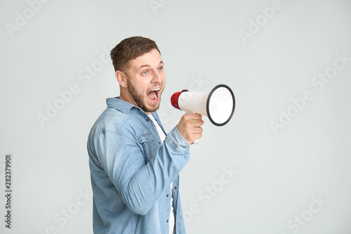 Young man with megaphone on...