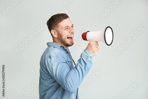 Young man with megaphone on...