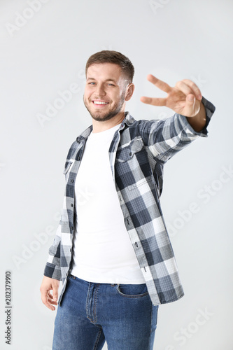 Handsome young man showing ...