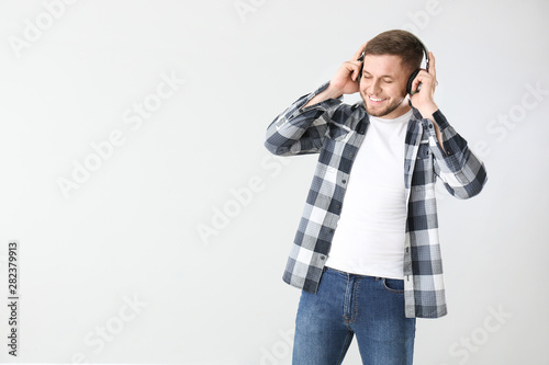 Handsome young man listenin...