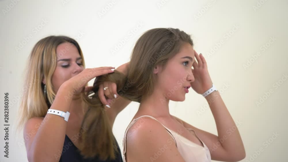 girls do hairstyles, portrait of cheerful female friends with long hair in sleepwear getting ready for a stylish evening party on a happy weekend girls do hairstyles, portrait of cheerful female friends with long hair in sleepwear getting ready for a stylish evening party on a happy weekend