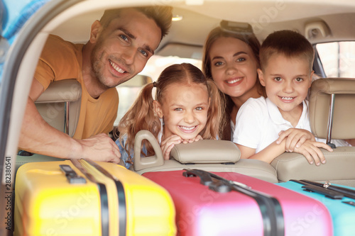 Happy family in car with pa...