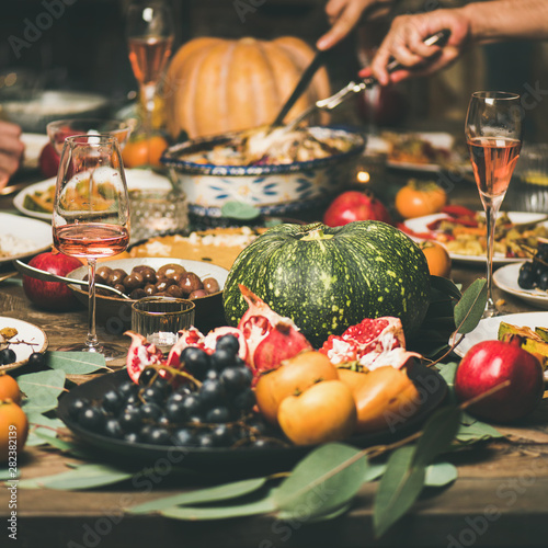 Traditional Christmas or New Year holiday celebration party. Friends or family eating different snacks at Festive Christmas table, selective focus, square crop