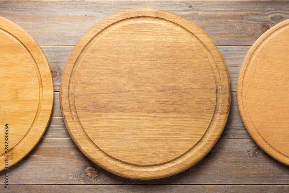 cutting pizza board at wooden plank table cutting pizza board at wooden plank table