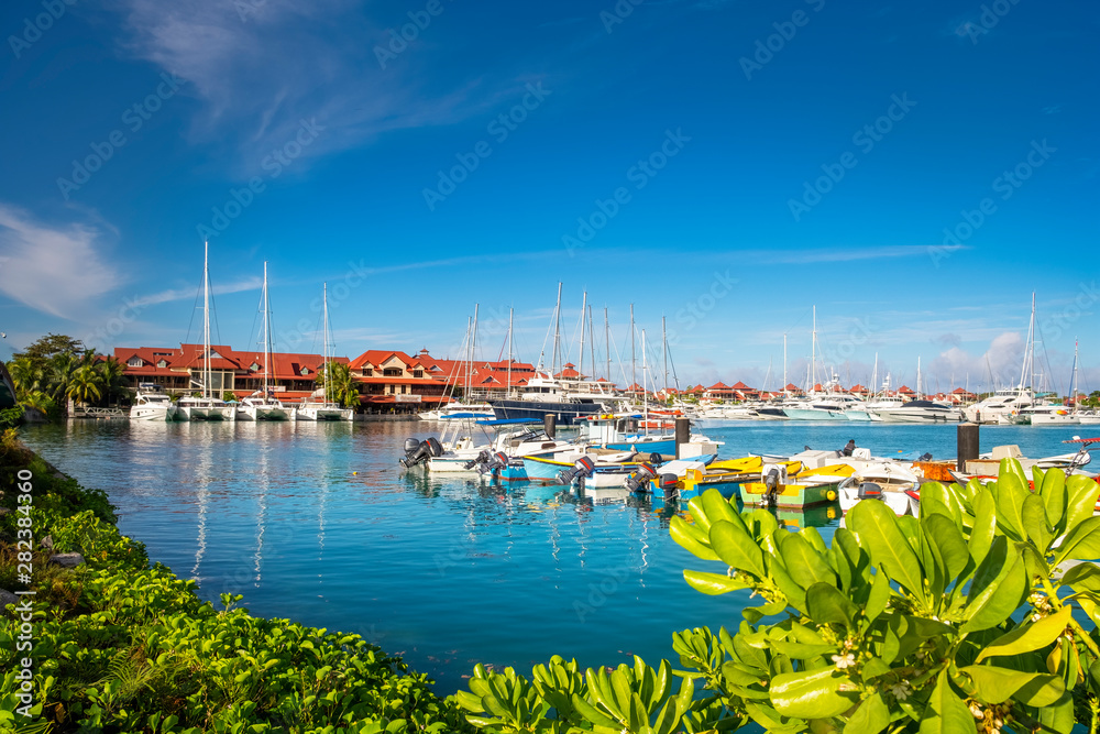 Luxury yachts and Boats  in sunny summer day at marina of Eden Island, Mahe, Seychelles
