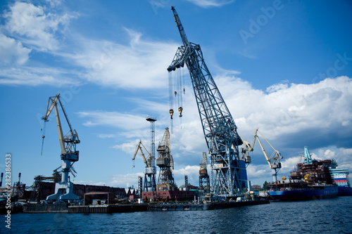 cargo port cranes against blue sky