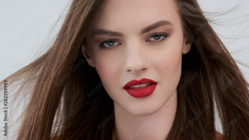 Portrait of a beautiful young woman with red lips. Stunning girl with long straight hair. Sensual fashion model. Portrait of a beautiful young woman with red lips. Stunning girl with long straight hair. Sensual fashion model.