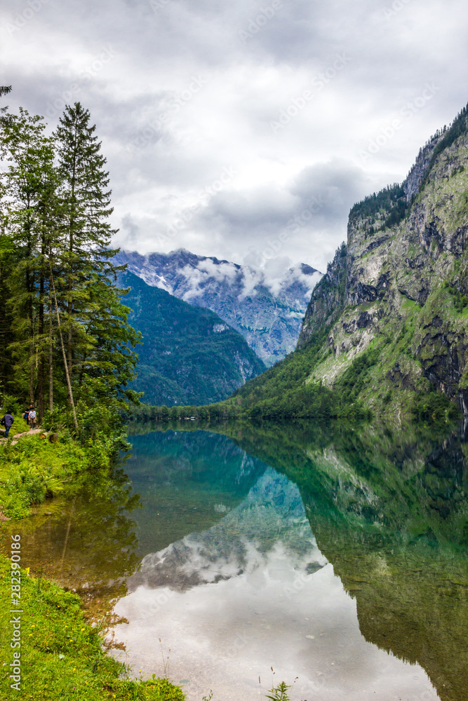 clouds over mountain lake Obersee in Alps
