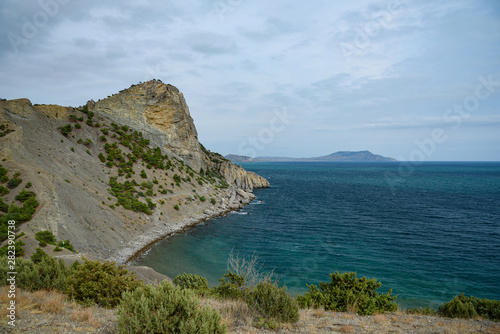 View of the Black Sea from a high point of the village Noviy Svet, on a cloudy day with clouds in the sky.