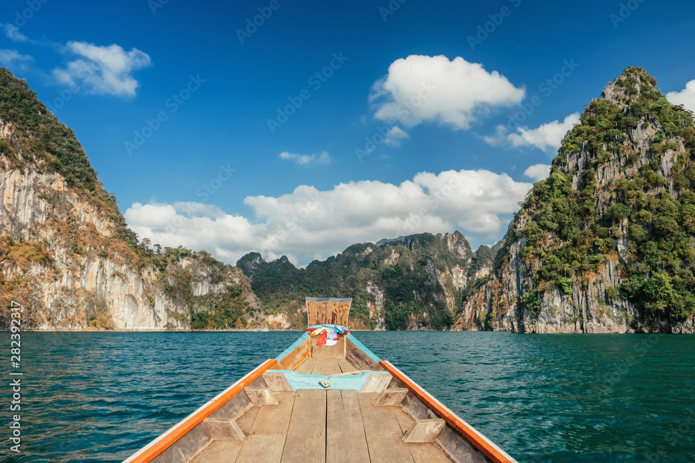 Wooden traditional thai longtail boat on Cheow Lan lake in Khao Sok National Park