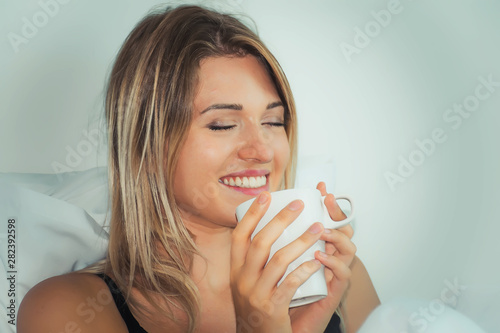 Cheerful young woman with coffee time in the morning at home.