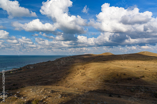 The beaches of the generals of the Crimean peninsula on a sleepy day with clouds in the sky, shot during the season of golden autumn yellow-golden brown. photo