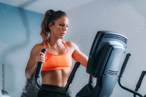 Woman Exercising on Elliptical Cross Trainer