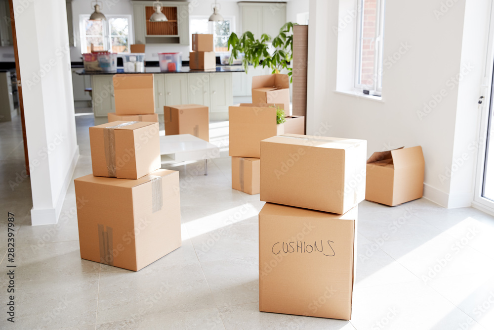 Stacked Removal Boxes In Empty Room On Moving Day Stacked Removal Boxes In Empty Room On Moving Day