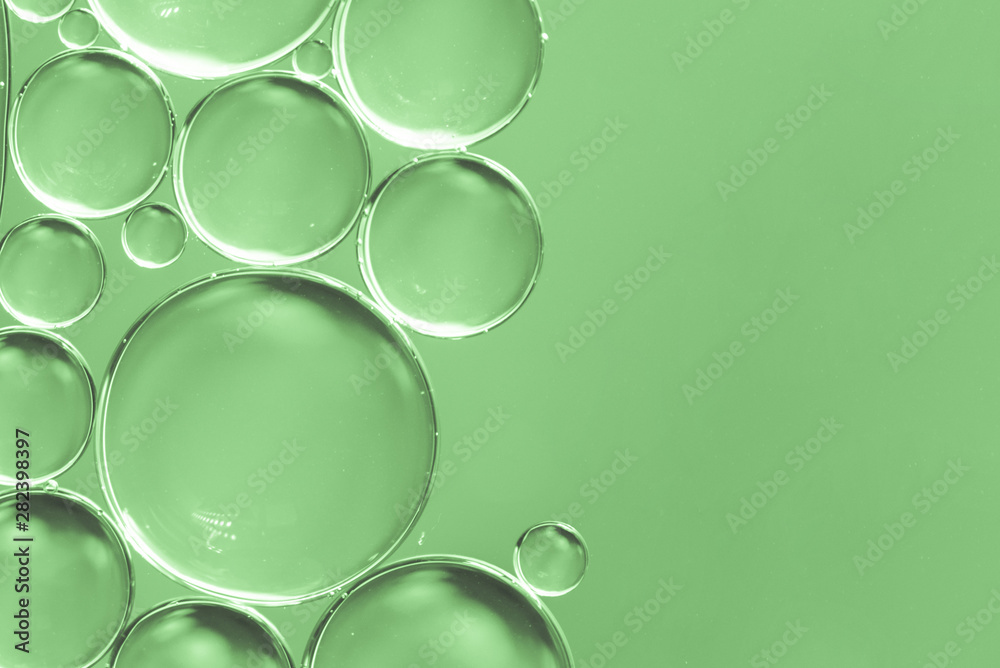 Abstract air bubbles in liquid on green background