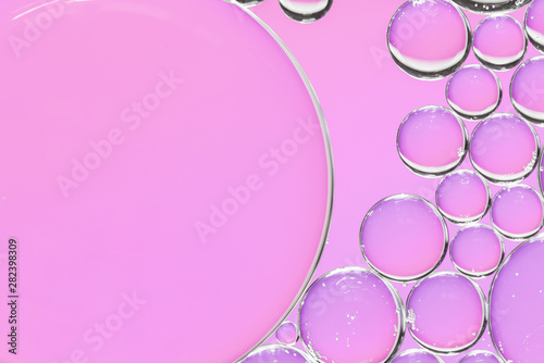 Abstract air bubbles in liquid on pink background