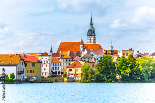 Jindrichuv Hradec cityscape. Church of the Assumption of the Virgin Mary and Vajgar pond in the foreground. Czech Republic