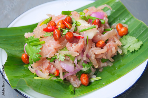 Thai traditional food fermented ground pork, fresh red and green chilli on fresh whole banana leaf