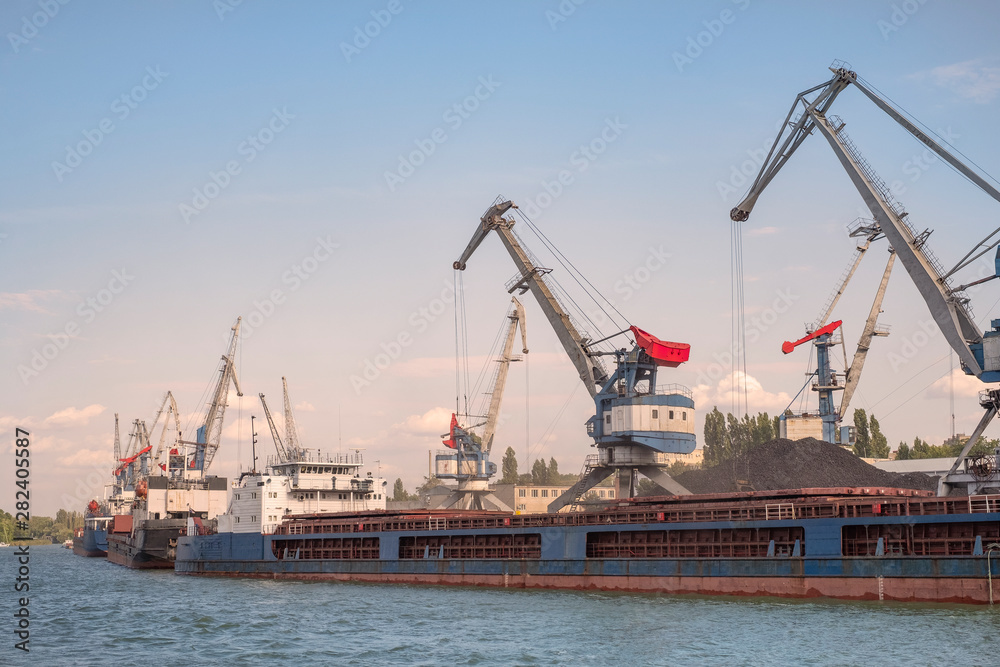 Cargo port , barges are for loading coal. Portal cranes , ship's queue for loading. Russian river cargo port. Cargo port , barges are for loading coal. Portal cranes , ship's queue for loading. Russian river cargo port.