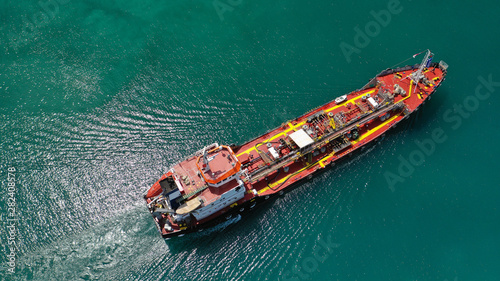 Aerial top view photo of industrial fuel supply vessel cruising in Mediterranean port