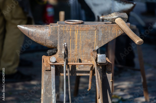 close-up of an old rusty blacksmith anvil with a hammer
