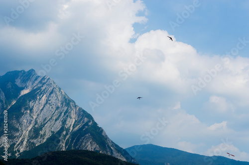 Hang glider flies over the beautiful peaks of the Alps