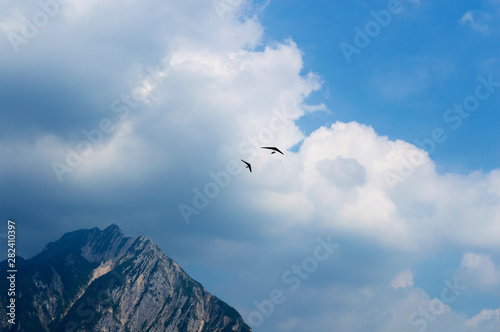 Hang glider flies over the beautiful peaks of the Alps