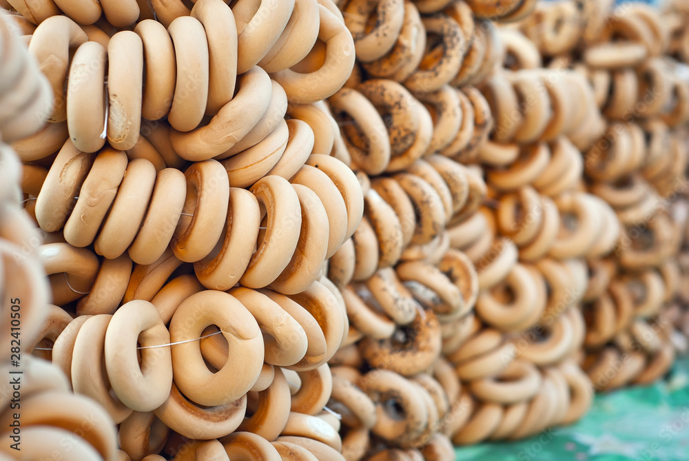 Many different bagels are sold at the city fair. Wheat products are tied with rope. Many different bagels are sold at the city fair. Wheat products are tied with rope.