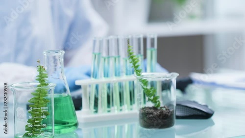 Scientist working in the lab with various tools on the table in modern research facility