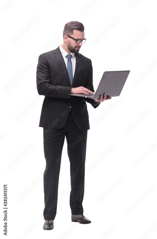 in full growth. businessman with open laptop. in full growth. businessman with open laptop.