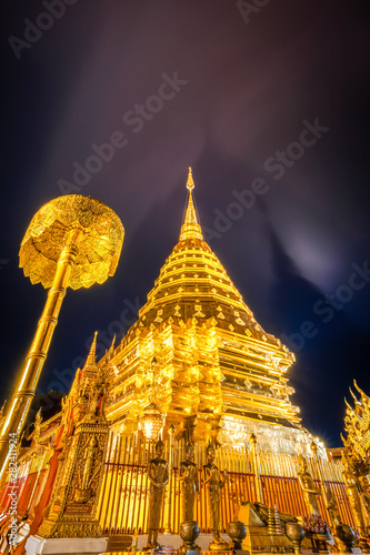 Shadow Pagoda of Doi Suthep Temple elics touching clouds during the night of rainy season, Chiang Mai, Thailand.