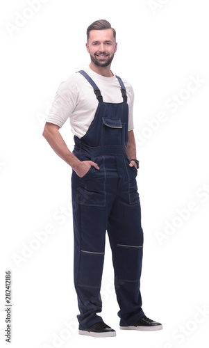 side view. smiling man in overalls looking forward to copy space