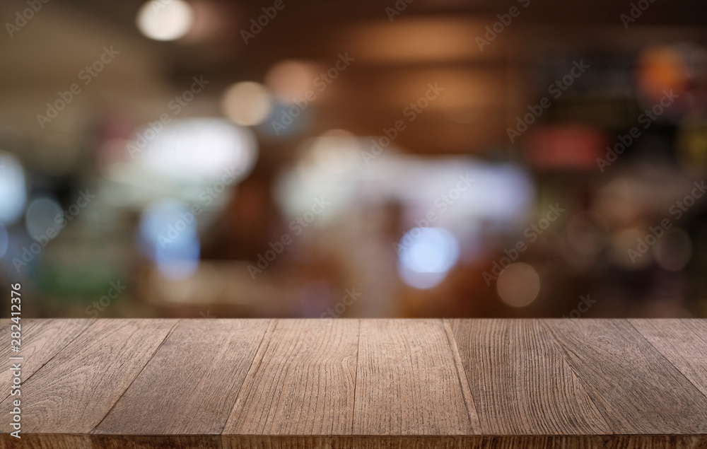 Empty dark wooden table in front of abstract blurred bokeh background of restaurant . can be used for display or montage your products.Mock up for space. Empty dark wooden table in front of abstract blurred bokeh background of restaurant . can be used for display or montage your products.Mock up for space.