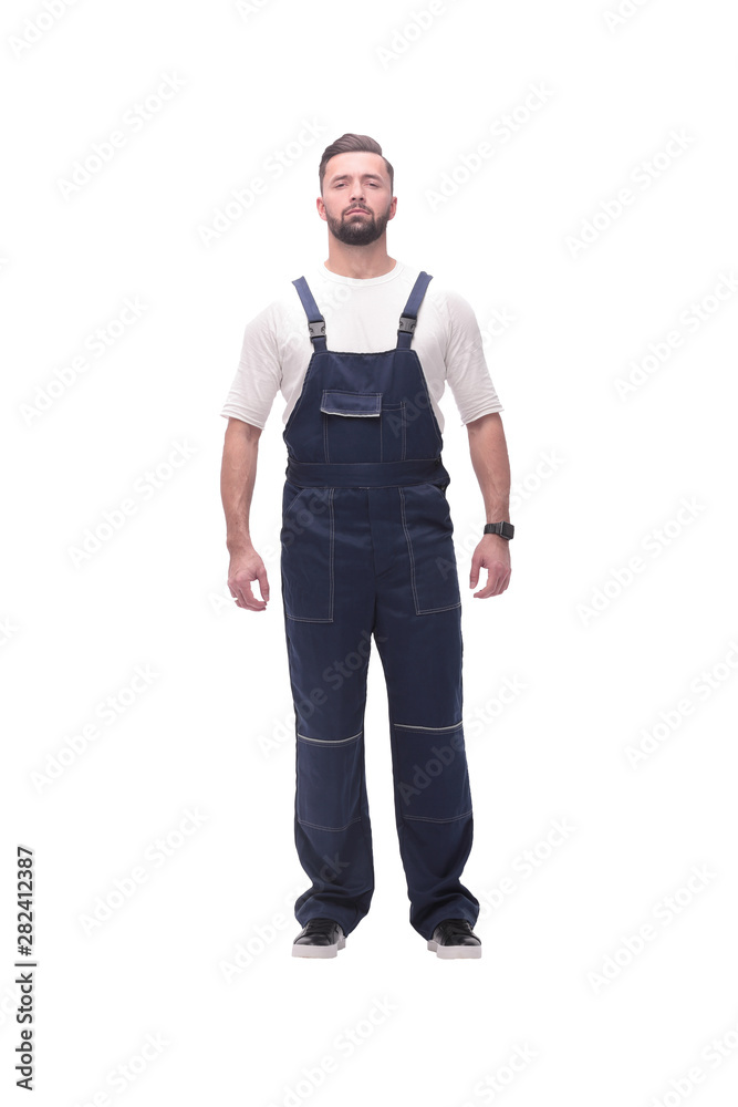 confident young man in blue overalls . isolated on white confident young man in blue overalls . isolated on white