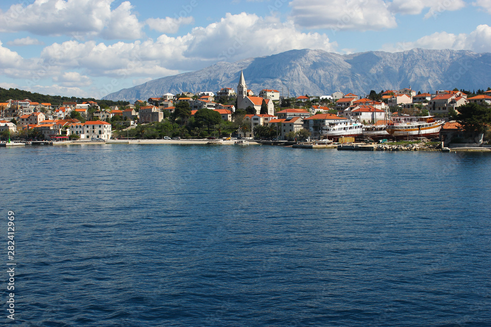 Panoramic view of picturesque village Sumartin on Brac island, Croatia. Shot from the ferry leaving from Sumartin to Makarska.