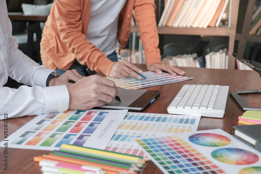 Graphic designer working on digital tablet. artist drawing on graphic tablet and Color swatch samples. Graphic designer working on digital tablet. artist drawing on graphic tablet and Color swatch samples.