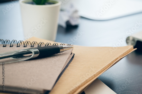 Pen and notebook up close on an office desk